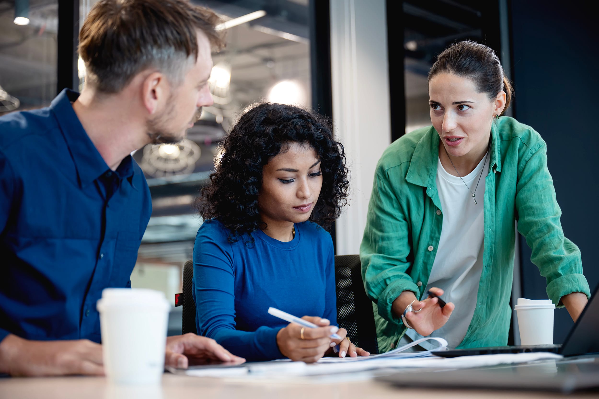 Aligning strategy and culture with the operating model to running your business successful. A business development team on informal meeting to review business process at a meeting room in a modern business office.